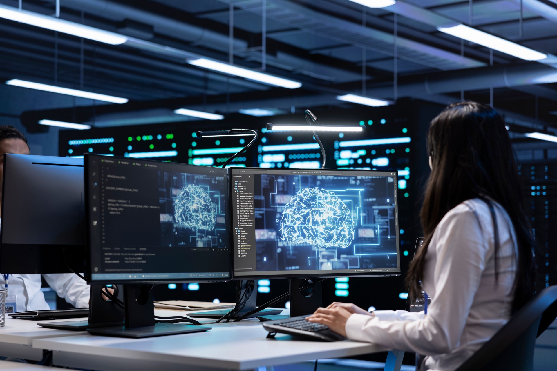 Technician using computer to do checkup in AI server room